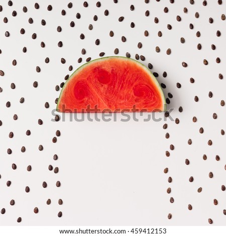 Watermelon slice with seeds raining. Flat lay. Weather concept.