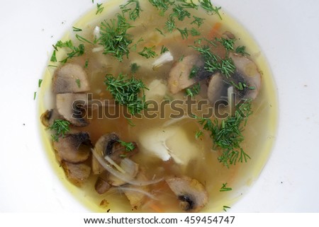 White plate with mushroom soup in a restaurant