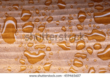 Drops of water on wooden background. Closeup of rain drops