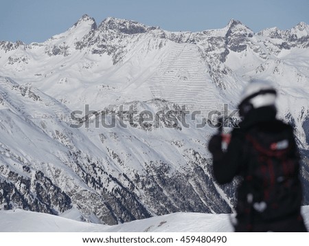 person photographing winter landscape