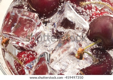 Beautiful cherries in water with bubbles