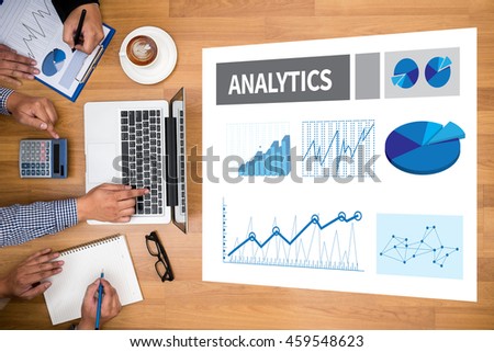ANALYTICS (Analysis Analytic Marketing  Graph Diagram) Business team hands at work with financial reports and a laptop