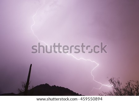 lightning across the mountain in Arizona. Summer is the monsoon season in Arizona, photographer go out and take this picture of lightning across a mountain