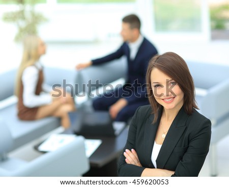 Young business woman standing with her collegues in background a