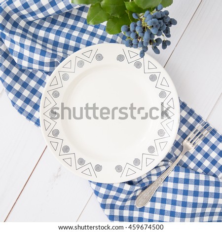 Empty white ceramic dish on a wooden table. View from above