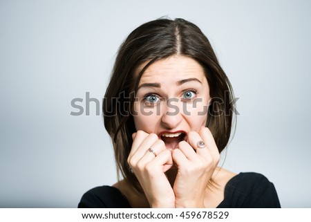 young woman pleasantly surprised studio photo isolated on a gray background