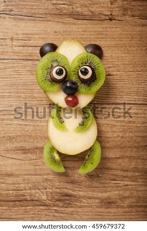 Panda made of pear on wooden background
