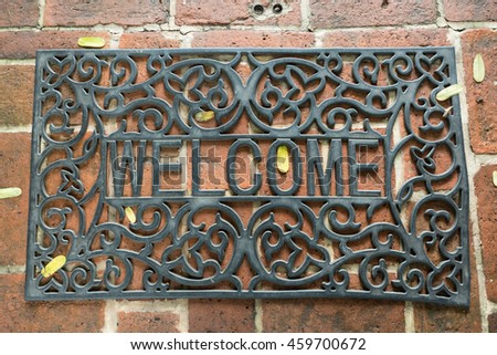 Welcome mat on brick background