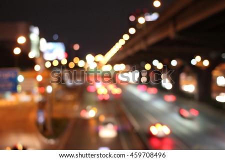 Abstract circular bokeh motion lens blur backround of city and street light on rainy day at night  in Thaialnd