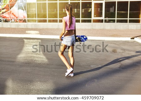 Beautiful young woman with skateboard