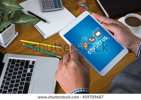 CONTACT US (Customer Support Hotline people CONNECT ) Businessman sitting at office desk  and holding  digital tablet,  coffee break,