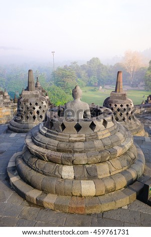 small stupa around top of Borobudor, world largest buddhist temple in Yogyakarta, Indonesia. Picture taken with the sunrise.