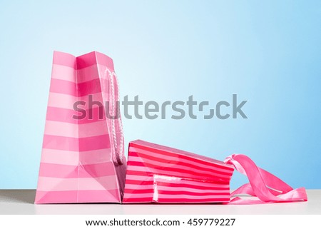 Shopping Bag of presents on white table.
