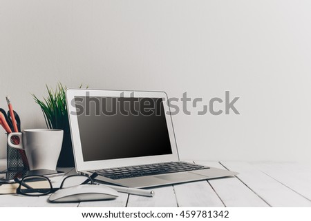 Laptop and other electronics on workspace