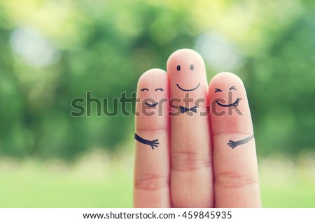 Happy finger art family group of loving mother and father with son while smiley face at blurred outdoor park background. Retro filter effect. copy space.