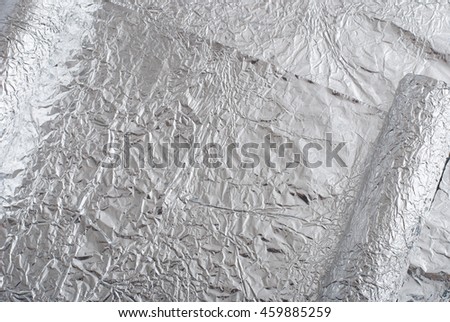 Silver foil figures with shiny crumpled surface. Contemporary art