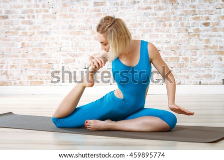 Young Beautiful Woman Practicing Yoga Doing Excercise On Brick Wall Ball Background