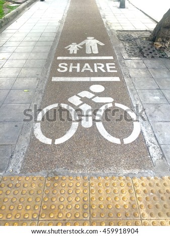Painted signs on footpath for pedestrian and bicycle dedicated lane