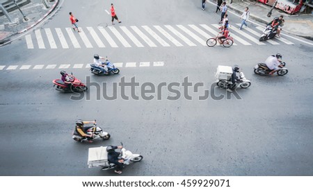 street on the top view with people are going acroos crosswalk sign on the road and car and motorcycle (Aerial photo)