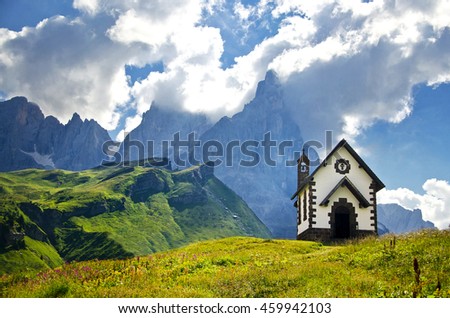 Alone chapel under the dolomite, Italy, Europe - Passo Rolle. Original picture with symbol of christianity.