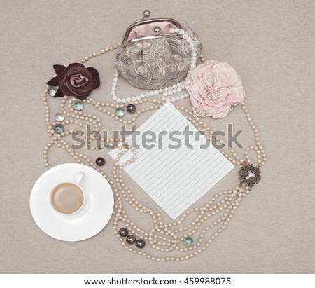 beads, pearls, delicate lace bag, photo frame, recording sheet, fabric roses,on linen cloth background,  top view
