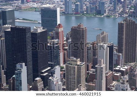 Aerial establishing photo of buildings rooftops in New York City on a clear summer day from high above