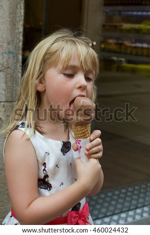young girl eating ice cream gelato outside