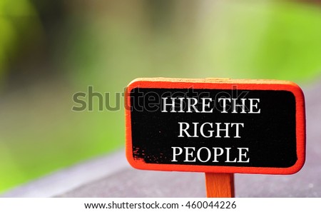 conceptual image, word HIRE THE RIGHT PEOPLE on black orange board frame with shallow DOF . blur green background. copy space
