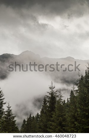 Mountain scenery in the Transylvanian Alps in summer, with mist clouds