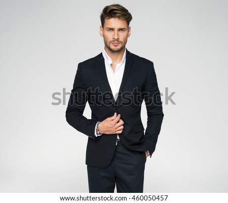 Portrait of handsome man in black suit Royalty-Free Stock Photo #460050457