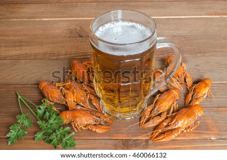 boiled crayfish with parsley on a wooden table