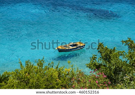 Wooden fishing boat floating on the colourful water