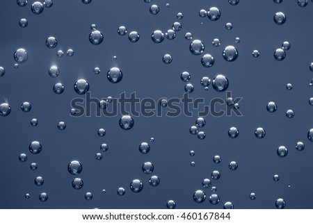 abstract quicksilver drops on a gray background, metallic texture.