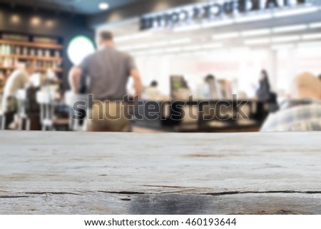 Selected focus empty brown wooden table and Coffee shop blur background with bokeh image. for your photomontage or product display
