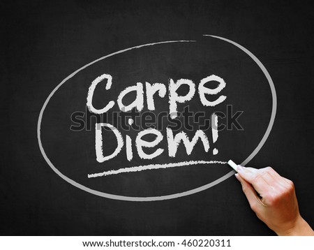 A hand writing 'Carpe Diem!' on chalkboard.