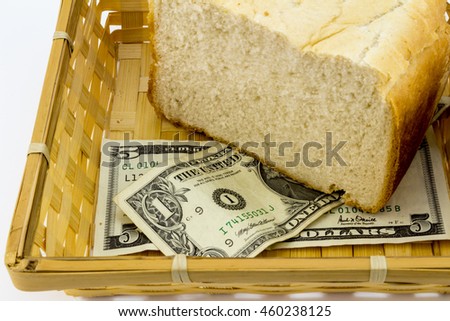 Closeup of bread and dollar bills in basket