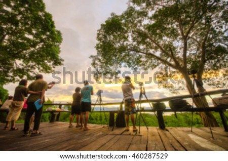 Blurred photographer taking picture of landscape during sunset at view point at Kanchanaburi.