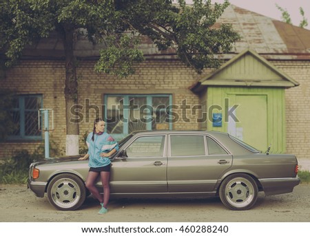 The girl in the nineties is about cars Royalty-Free Stock Photo #460288240