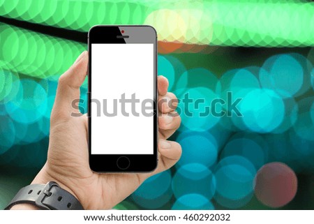 Man hand holding white screen smartphone on abstract cool tone bokeh as background