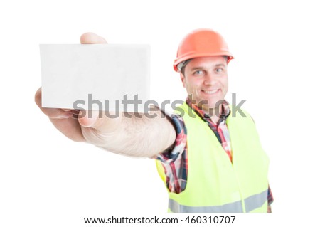 Handsome builder showing blank visit or business card with copyspace in close-up isolated on white background