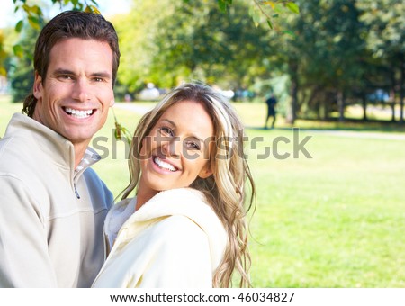 Young love couple smiling in park