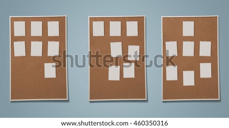 Blank photos pined on cork board