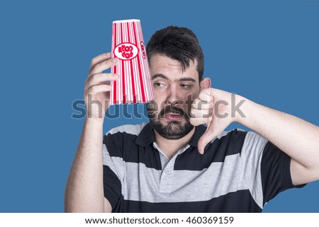 Portrait of young man eating popcorn