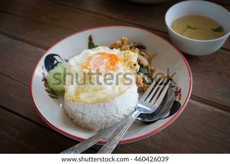 Thai stir-fried chicken and basil served with rice and fried egg, Thailand favorite food.