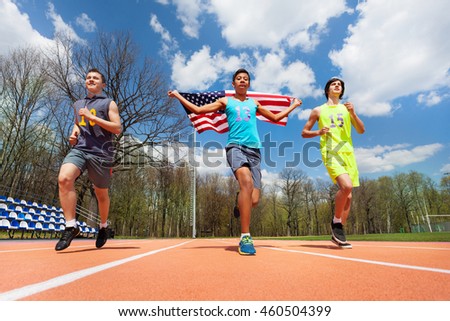 Winning runners with USA flag celebrating victory