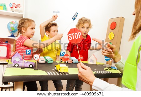 Cute kids having fun teaching traffic signs