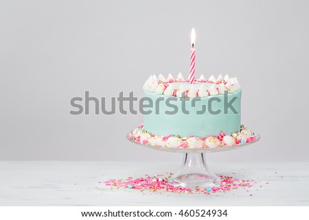 Pastel Blue Birthday Cake with Pink Sprinkles over White Background. Royalty-Free Stock Photo #460524934