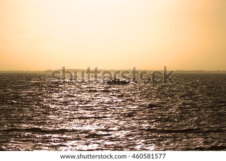 Fishermen at sunset on the high seas