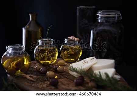 Dark photography. Infused olive olive with thyme, sage and pickled olives. 