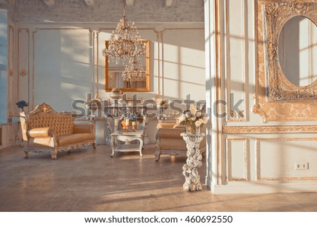 rich interior of studio with gold decorations on the walls at sunset time